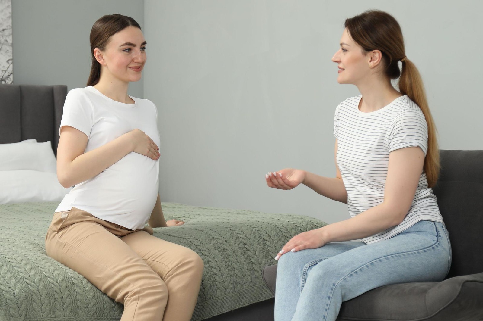 Doula working with a pregnant woman preparing for childbirth
